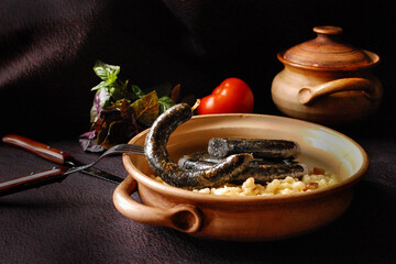 Black homemade baked sausage with spätzle