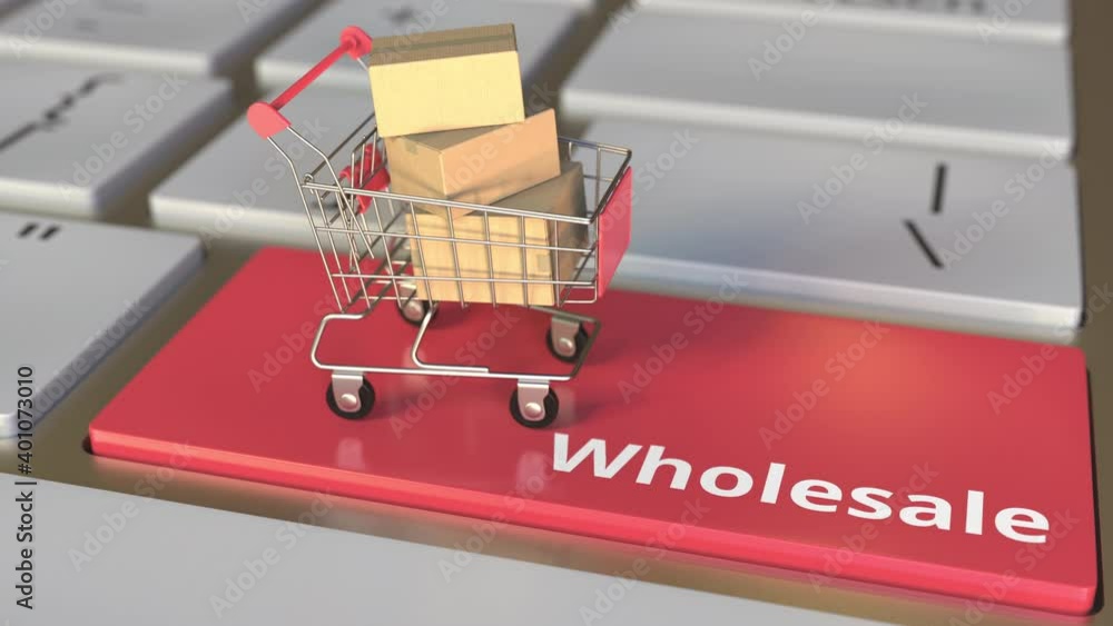 Poster wholesale text on computer keyboard and boxes in small shopping cart. electronic business conceptual