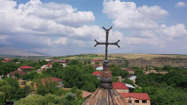 Cross closeup of Saint Gevorg monastery in Mughni, drone 4K shot