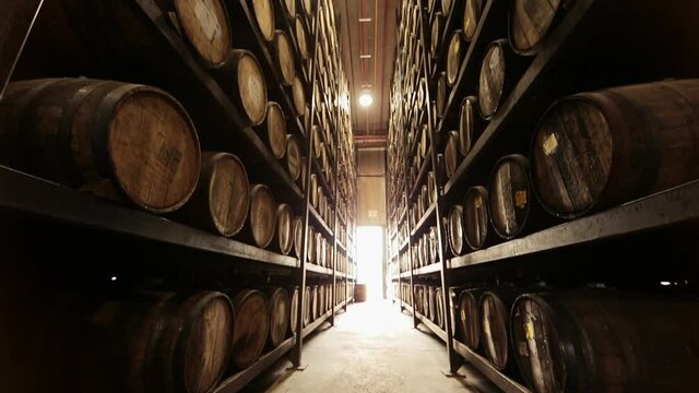 Barrels of tequila on shelves in warehouse
