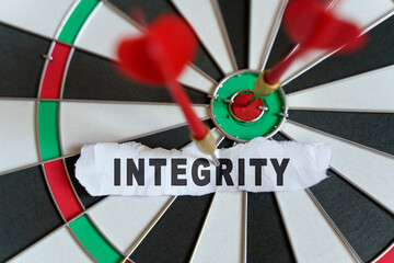 A piece of paper with the text is nailed to the target with a dart - INTEGRITY