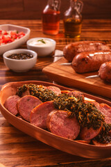 Brazilian pork sausage portion with chimichurri - Close up