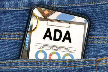 In a pocket of jeans there is a smartphone on the screen of which the text - ADA