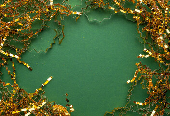 Fototapeta na wymiar gold festive copper chip paper on green background