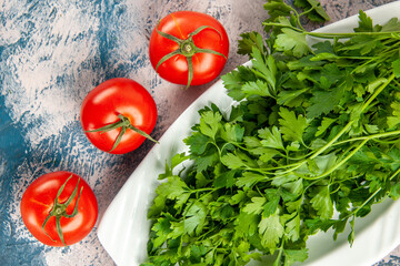 top view fresh greens with tomatoes on a light-blue background ripe salad photo meal color
