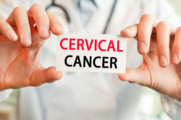 Doctor holding a card with text CERVICAL CANCER