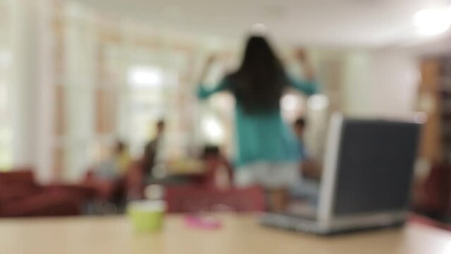 Defocused shot of man joining woman dancing in cafe