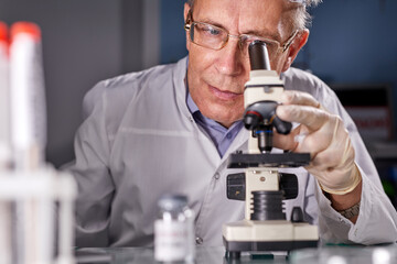 microbiologist hold test tube and microscope in lab, finding vaccine for coronavirus infection. covid-19, laboratory, and vaccine concept.