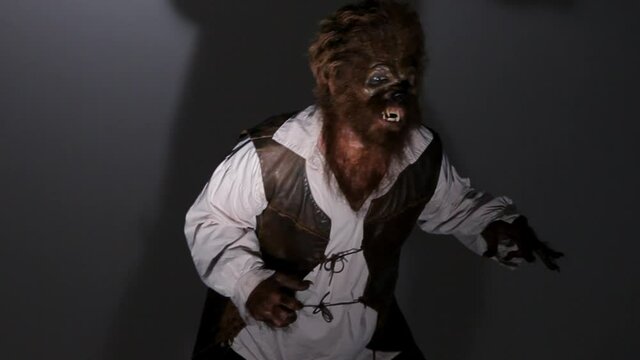 Angry male werewolf swaying and growling