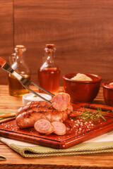 Brazilian BBQ fork serving pork sausage - Churrasco de linguiça de suina close up