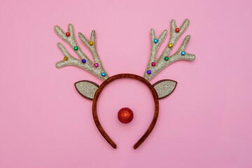 Reindeer head made of head decoration with red bauble. Minimal Christmas concept