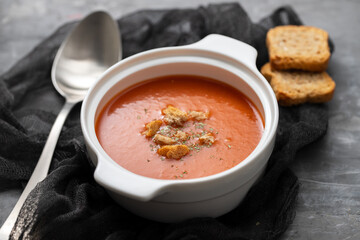 tomato soup in white bowl on red background