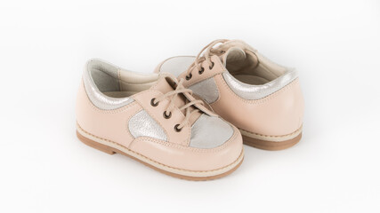 children's beige orthopedic shoes on a white background