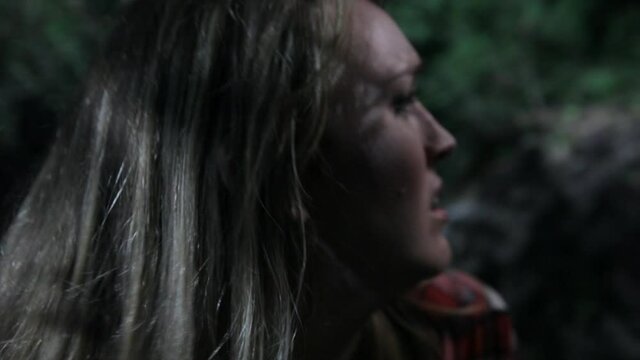 Close up of Caucasian woman screaming in fear in woods
