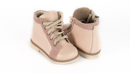 children's beige high orthopedic lacing shoes on a white background