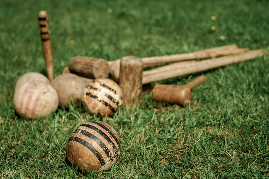 Vintage croquet set on green ground, clubs and balls made of wood
