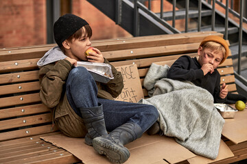 two beggar boys in the cold weather outdoors, child abuse, social poverty problems