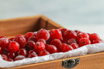 Frozen cranberries in a wooden box. Healthy food.