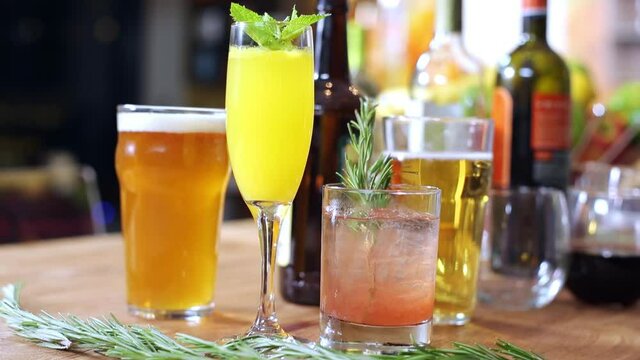 Close-up shot of different kinds of alcoholic beverages and garnishes.