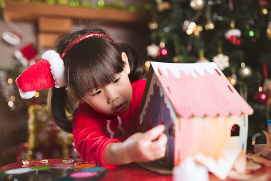 young girl making christmas craft at home