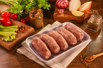 Brazilian pork sausage with chimichurri on white plate with spices and ingredients