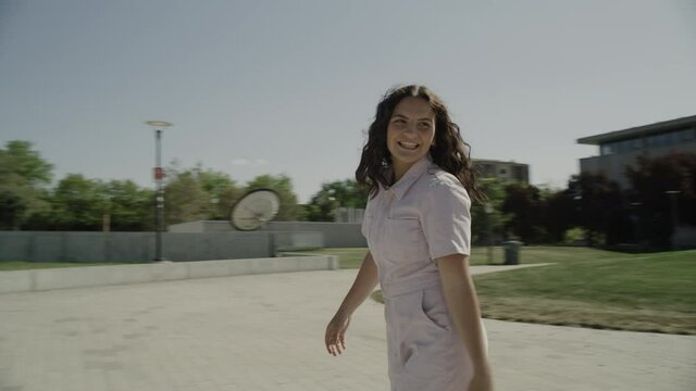 Slow motion tracking shot of girl looking at camera while roller skating / Salt Lake City, Utah, United States