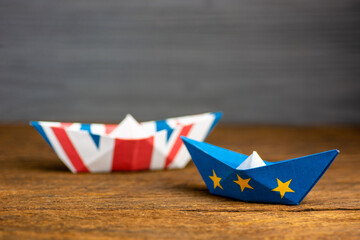 paper ship with british and european flag, concept shipment or free trade agreement and membership...