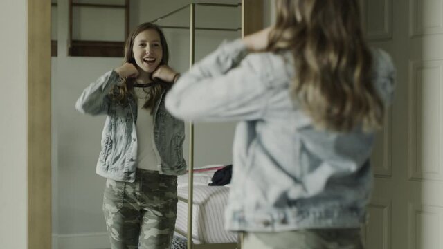 Compilation of smiling teenage girl trying on clothing in bedroom mirror / Cedar Hills, Utah, United States