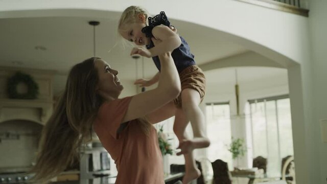 Slow motion of mother lifting and dancing with daughter / Cedar Hills, Utah, United States