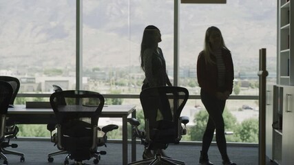 Businesswomen shaking hands at meeting then leaving conference room / Pleasant Grove, Utah, United States