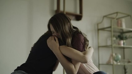 Close up of teenage girl hugging and comforting crying friend / Cedar Hills, Utah, United States