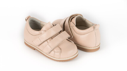 children's beige orthopedic shoes on a white background