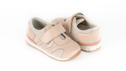 children's beige orthopedic shoes on a white background