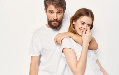 Cheerful man and woman t-shirts studio family lifestyle