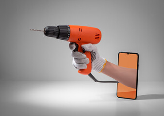 Hand holding a corded drill from out of a phone screen