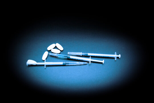 Pills and Syringes - drug addiction concept with copy space