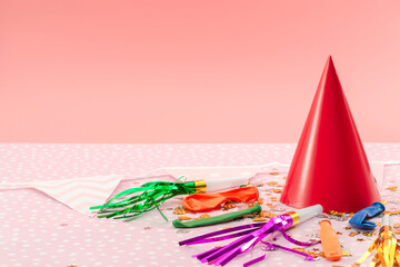 Happy birthday, kids party and joyful occasion concept with colourful decoration, balloons, cone hat and confetti isolated on pink background with copy space