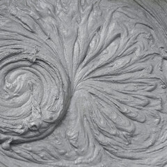 Wet cement. Wet gray mortar for finishing work in construction. Traces of rotation of the mixer in concrete, imprints on the cement. Close-up. Floral pattern, decorative drawing. Color of the year. 