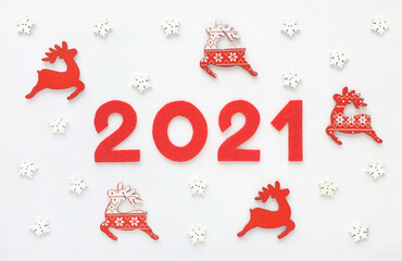 New year 2021 greeting card with red Santa Claus's reindeers and white snowflakes. Wooden...