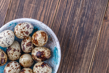 Fototapeta na wymiar Quail eggs on the wooden plate. Quail eggs can be consumed by frying or boiling. In Indonesia quail eggs called telur puyuh.