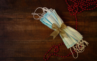 Christmas gift protective masks on wooden background