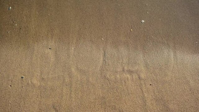 We're leaving behind a very bad year. 2020 written on the beach disappears into the waves. Goodbye 2020 welcome 2021