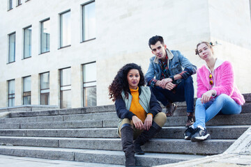 Obraz premium cute group of teenages at the building of university with books huggings, diversity nations real students lifestyle