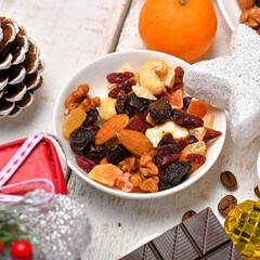 sweet food top view background for merry christmas or new year holiday decoration - chocolate candies, tangerines, cookies, marshmallow and cocoa latte on white wood