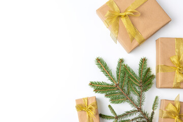 gift boxes wrapped in brown paper and tied with a golden ribbon on a white background