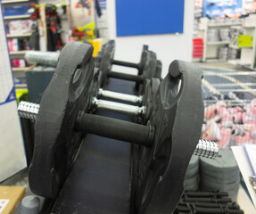 different weights from the bar and dumbbells in the sports store. sports concept.