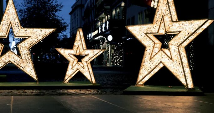 Christmas decorations and lights at Place Longemalle in Geneva downtown district of Rues basse which regroup the main shopping streets  as well as some of the oldest squares in the city.