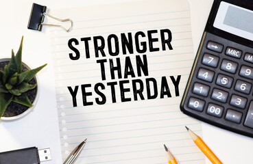stronger than yesterday white chalk text on a vintage slate blackboard.