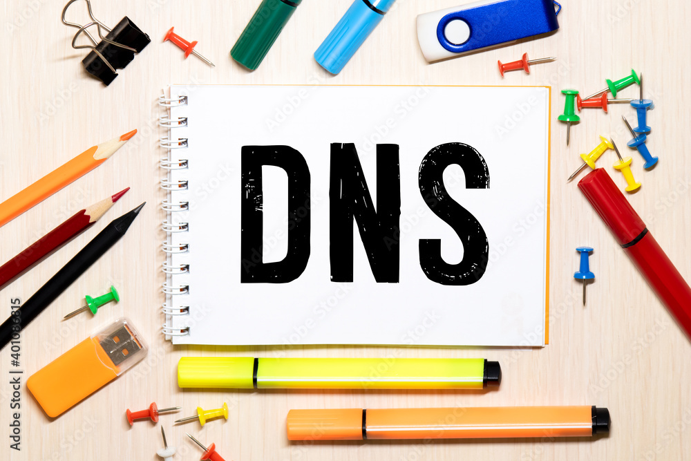 Poster dns, domain name system, text on white card next to notepad and pen on table