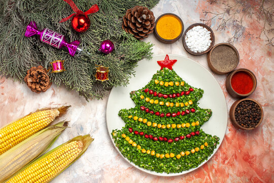 top view tasty green salad in new year tree shape with seasonings on light background holidays color photo meal health xmas